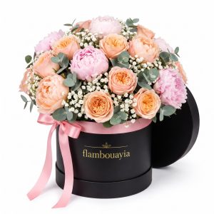 Peonies and garden roses with eucalyptus in a black flambouayia hat box